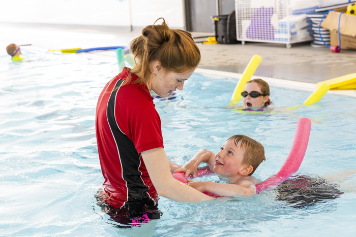 Child with swimming instructor